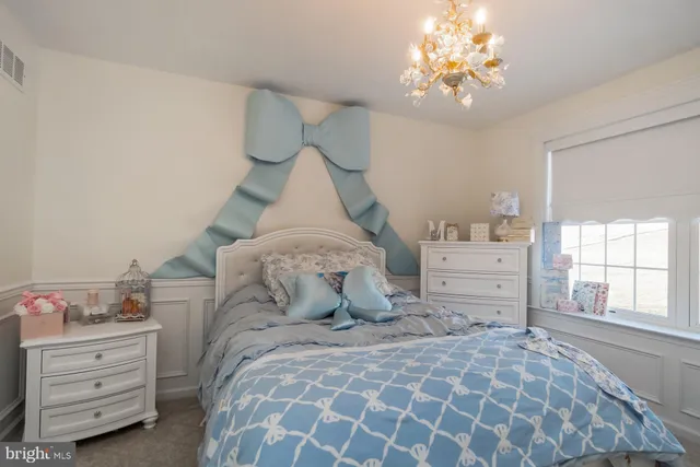 a bedroom with a bed and flat screen tv