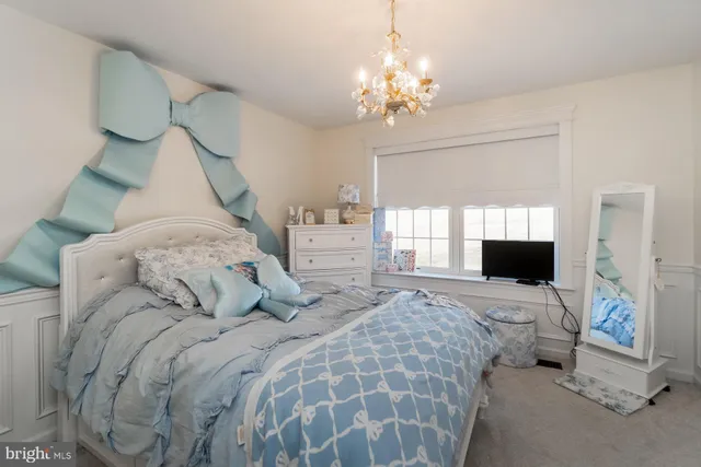 a bed room with a bed and a chandelier