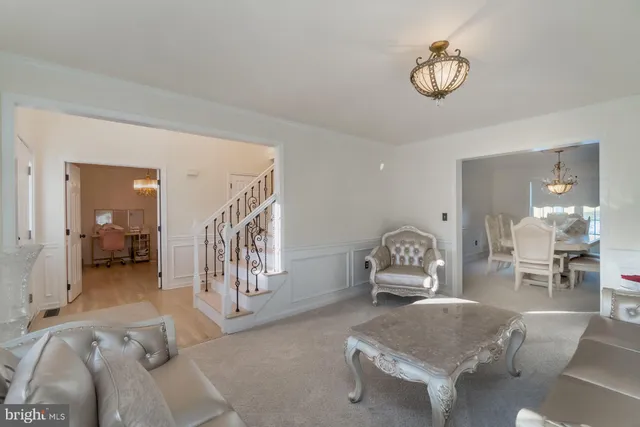 a dining room with furniture a chandelier and window