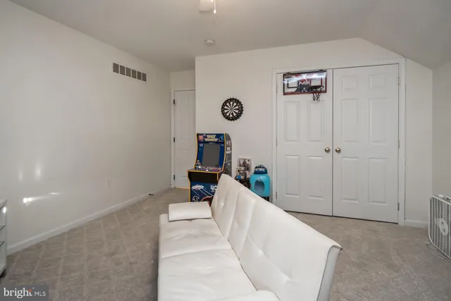 a view of a porch with chairs and floor to ceiling window