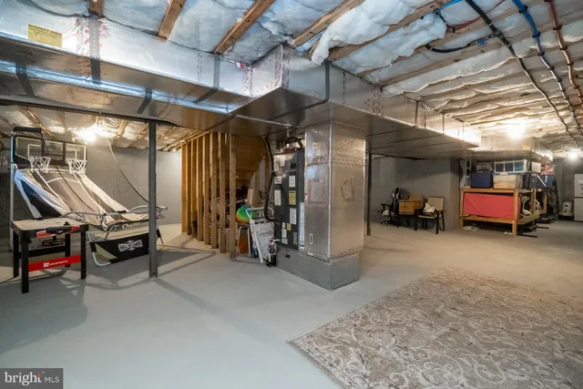 a view of a big house with a big yard and large trees