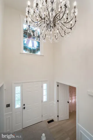 a kitchen with granite countertop white cabinets and white stainless steel appliances