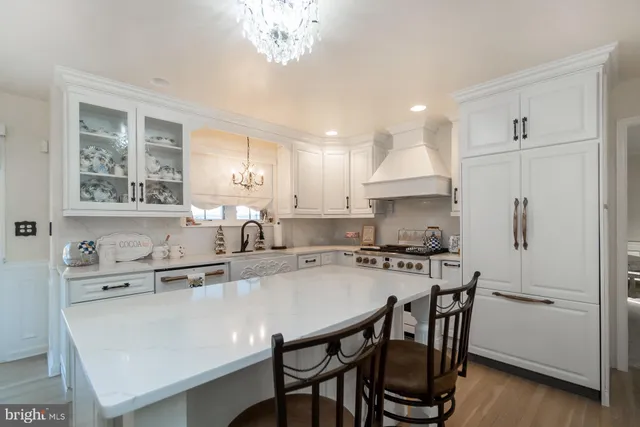 a kitchen with a sink a stove a refrigerator and cabinets