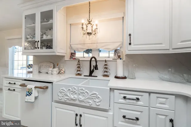 a kitchen with stainless steel appliances a dining table and chairs