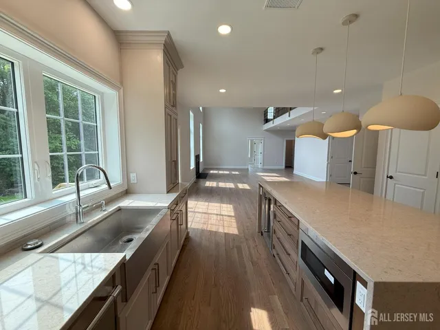 a kitchen with a stove a sink and a window