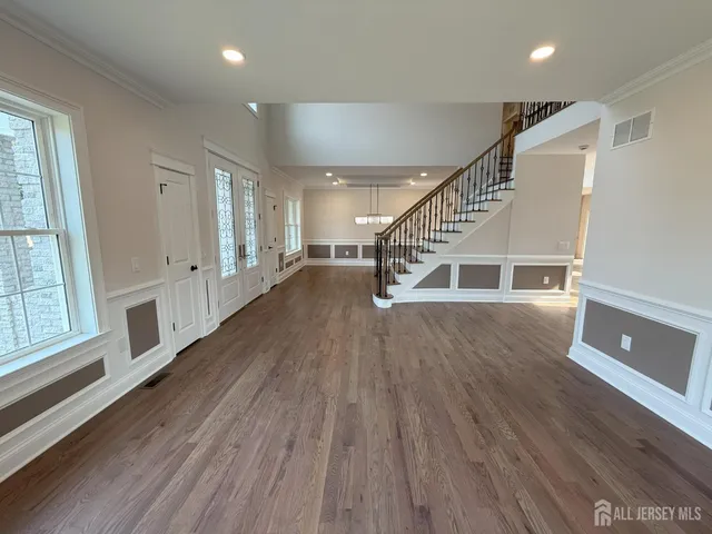 a view of a room with wooden floor windows and stairs