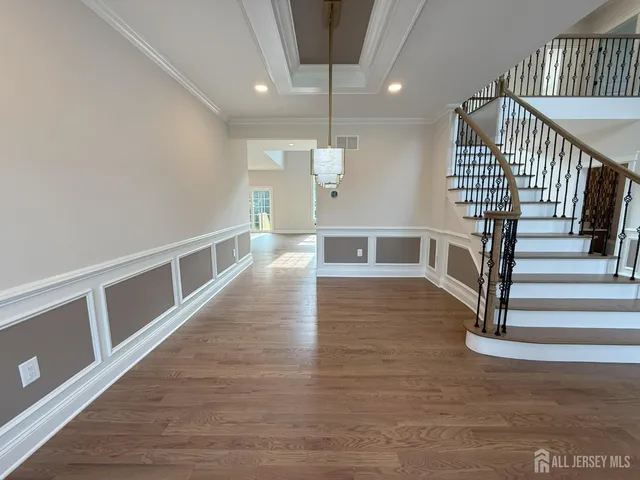 a large kitchen with stainless steel appliances kitchen island a large counter top and a view of living room