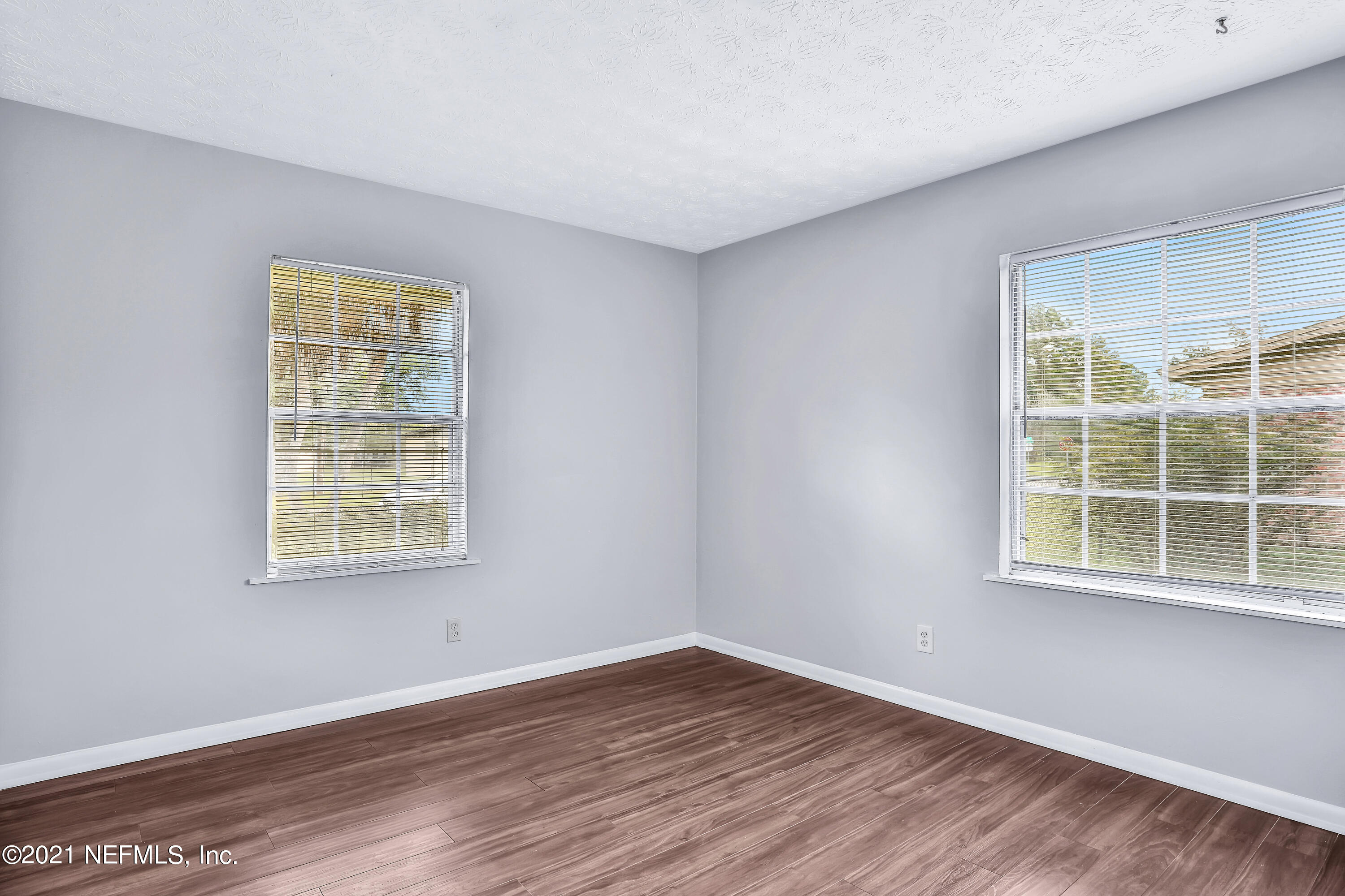 1212 Bacall Road Jacksonville, FL 32218 - Photo 21 of 23 a view of an empty room with wooden floor and a window