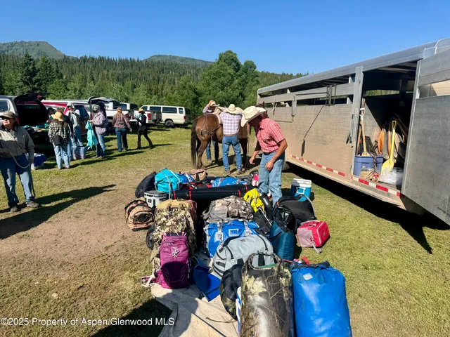 a view of a lush green field with sitting area