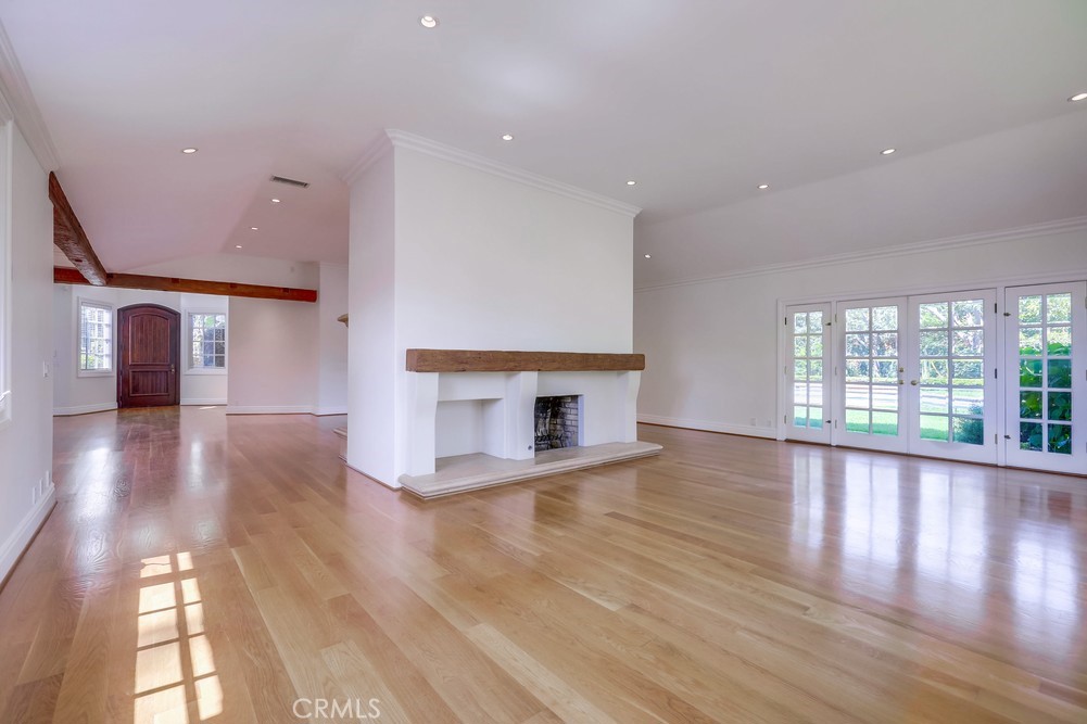 630 West Devon Place Long Beach, CA 90807 - Photo 16 of 49 a view of a hallway with wooden floor and a fireplace