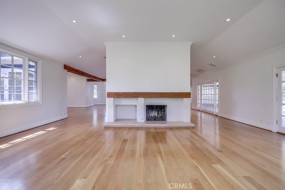 630 West Devon Place Long Beach, CA 90807 - Photo 17 of 49 an empty room with wooden floor fireplace and windows