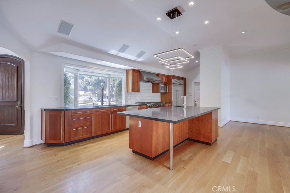 630 West Devon Place Long Beach, CA 90807 - Photo 21 of 49 a view of kitchen with granite countertop cabinets and wooden floor