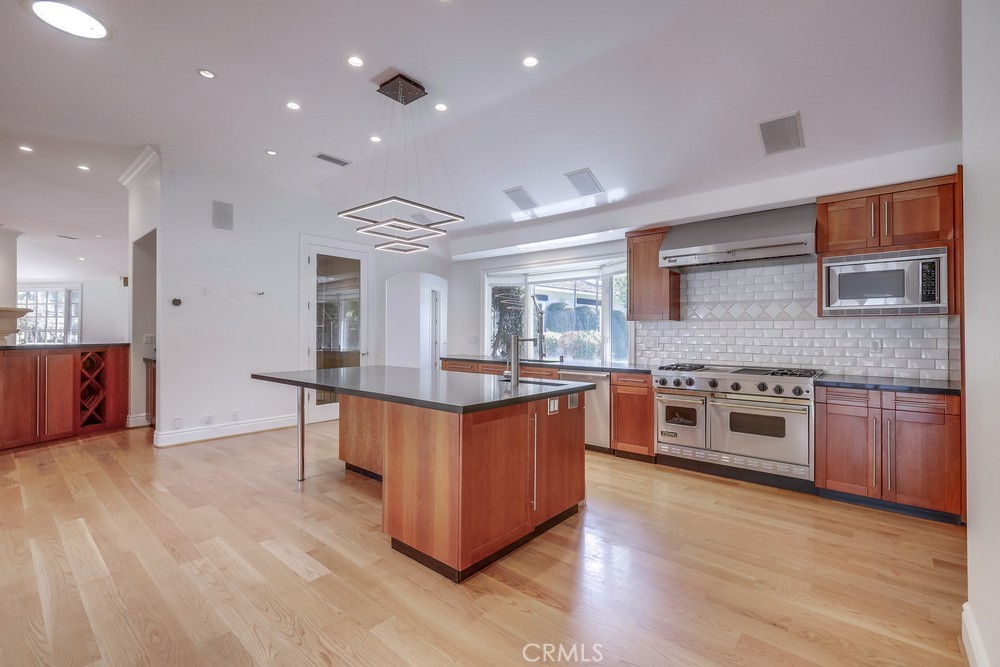 630 West Devon Place Long Beach, CA 90807 - Photo 22 of 49 a large kitchen with stainless steel appliances granite countertop a large counter top and a stove