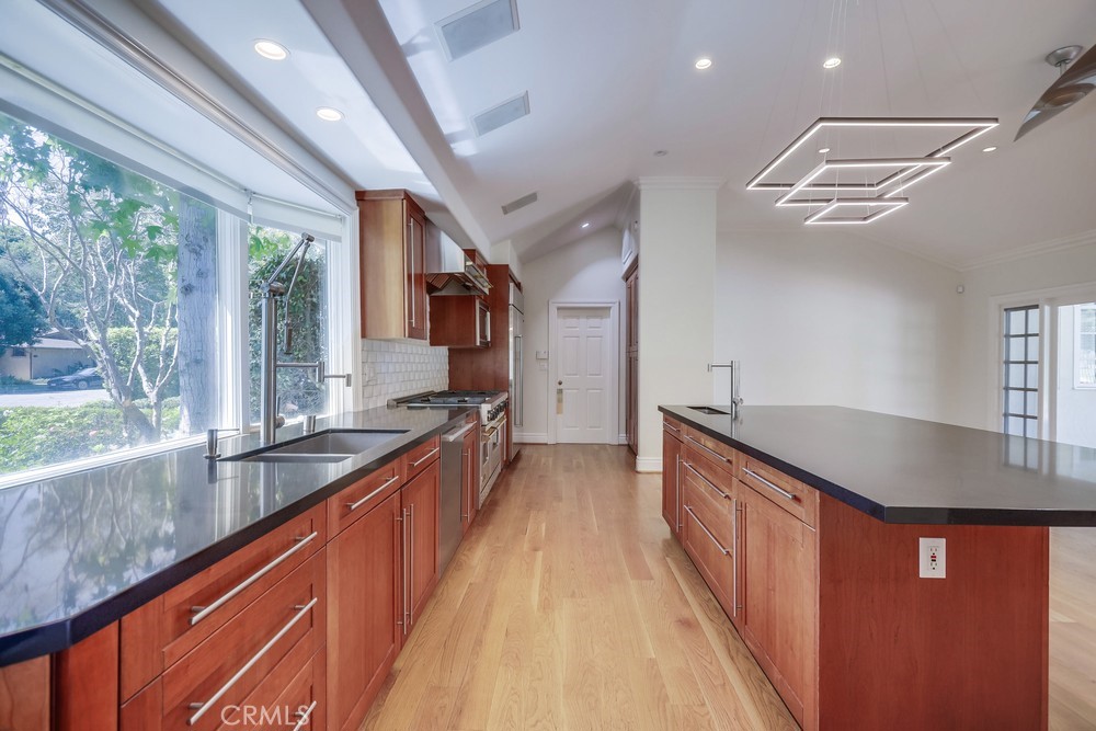 630 West Devon Place Long Beach, CA 90807 - Photo 24 of 49 a large kitchen with kitchen island a large window a sink and stainless steel appliances