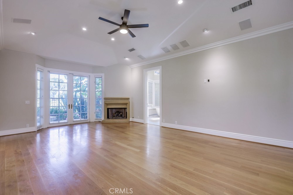 630 West Devon Place Long Beach, CA 90807 - Photo 28 of 49 an empty room with wooden floor fireplace and windows
