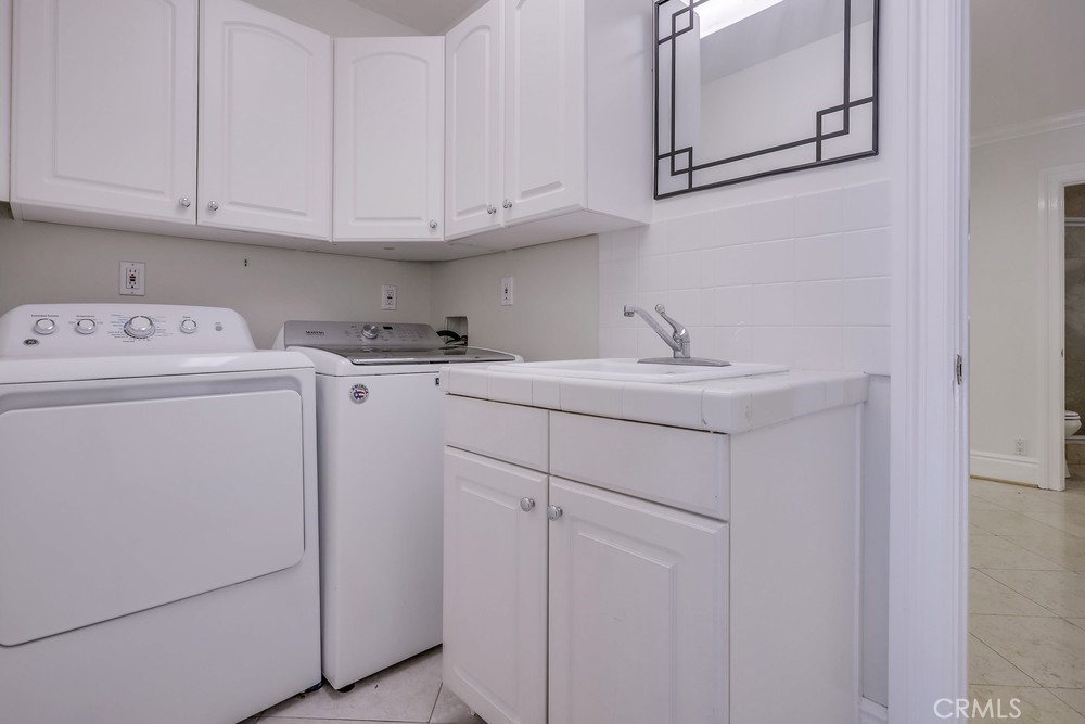 630 West Devon Place Long Beach, CA 90807 - Photo 40 of 49 a view of cabinets and washer dryer