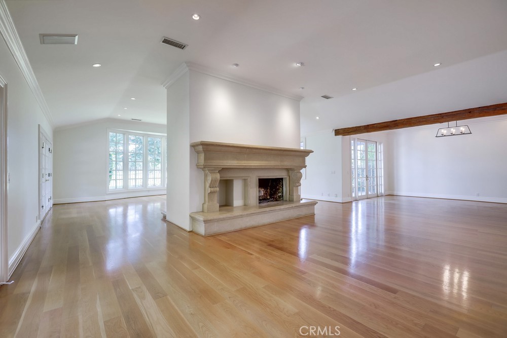 630 West Devon Place Long Beach, CA 90807 - Photo 10 of 49 a view of an empty room with wooden floor and fireplace