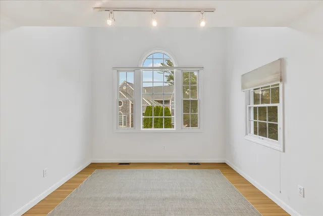 an empty room with a empty space and windows