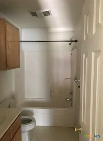 a bathroom with a bathtub and a toilet