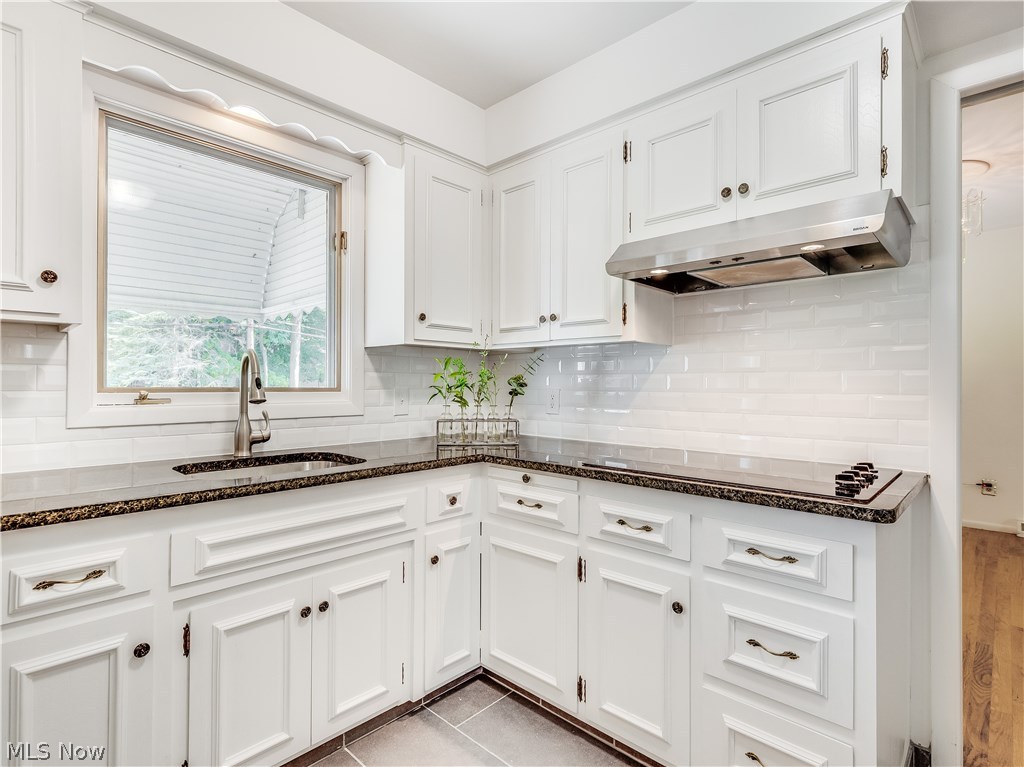 1047 Roland Road Lyndhurst, OH 44124 - Photo 6 of 26 The kitchen features refinished cabinets, brand-new stainless steel appliances, granite countertop, new sink and faucet, new ceramic tile flooring, new backsplash, and new light fixtures.