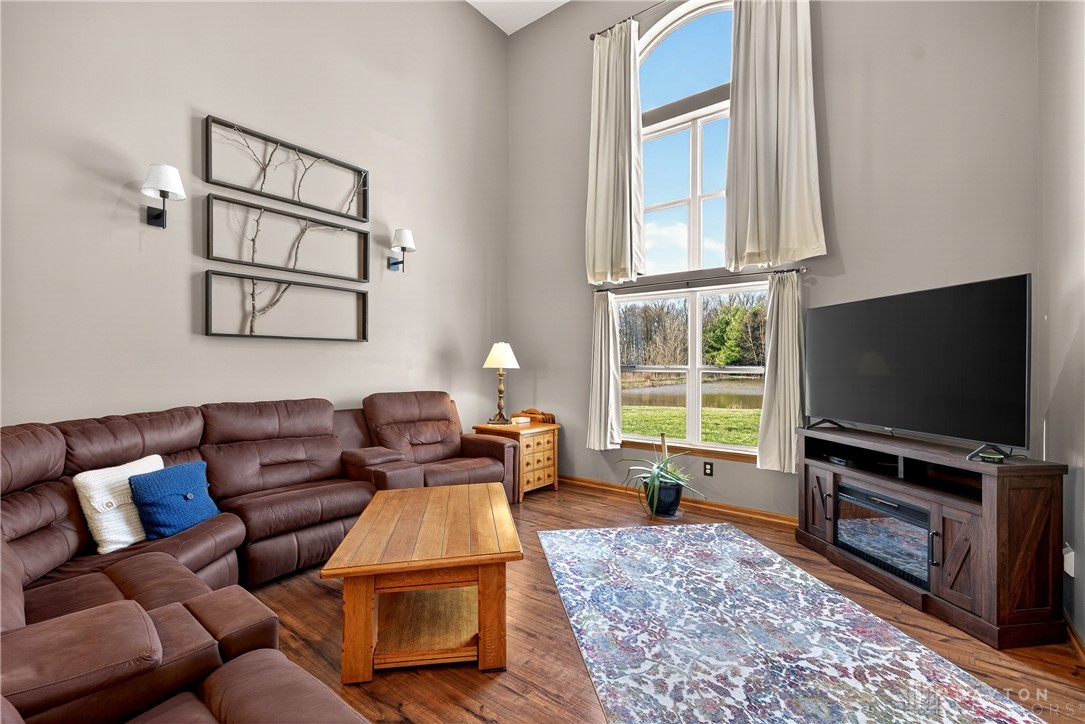 6560 Snyder Road Fletcher, OH 45326 - Photo 13 of 71 This inviting living area boasts high ceilings and abundant natural light from large windows.