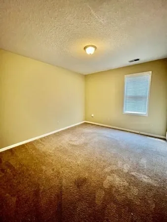 an empty room with a empty space and a window
