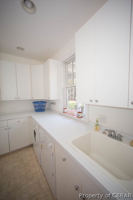 87 Eagle Point Road Lancaster, VA 22503 - Photo 24 of 36 a kitchen with a sink cabinets and window