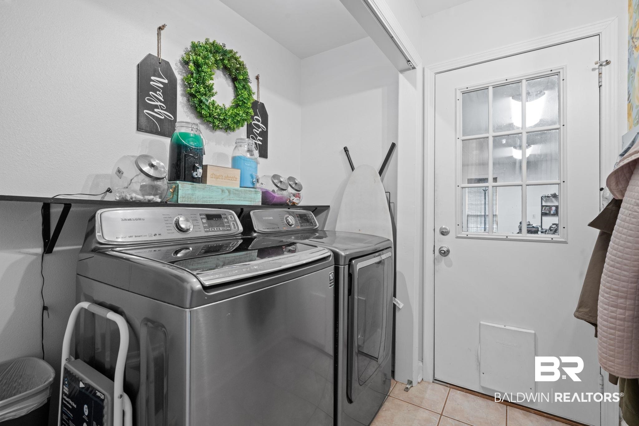 5936 Lundy Road Theodore, AL 36582 - Photo 21 of 32 Dedicated laundry area featuring a wall-mounted shelf, top-loading washer, front-loading dryer, and tiled flooring
