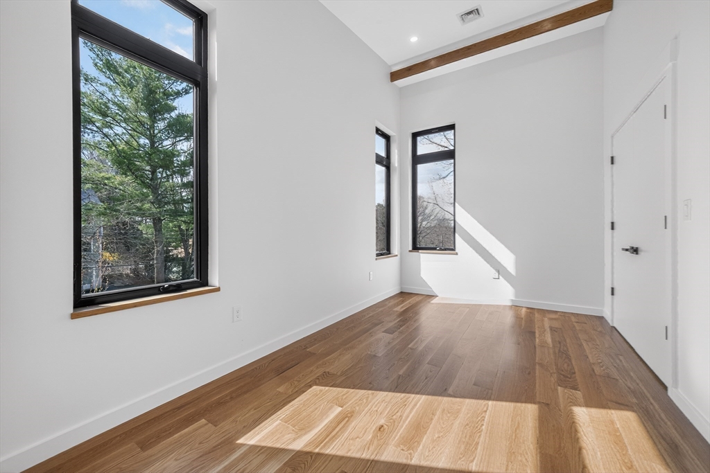 15 Bird Hill Road Lexington, MA 02421 - Photo 23 of 34 an empty room with wooden floor and windows
