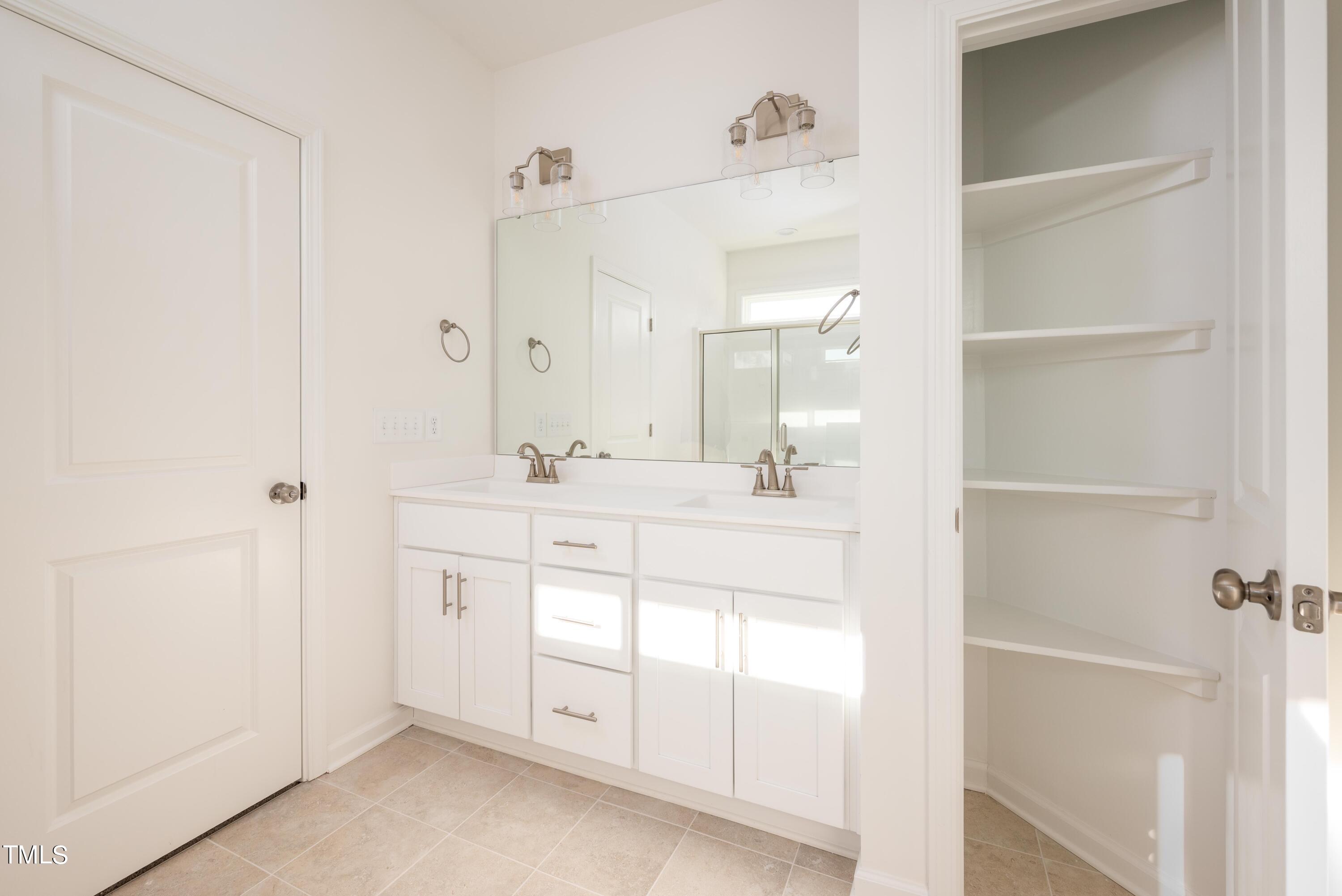 5080 Frazier Road Middlesex, NC 27557 - Photo 28 of 39 a bathroom with a sink vanity and a mirror