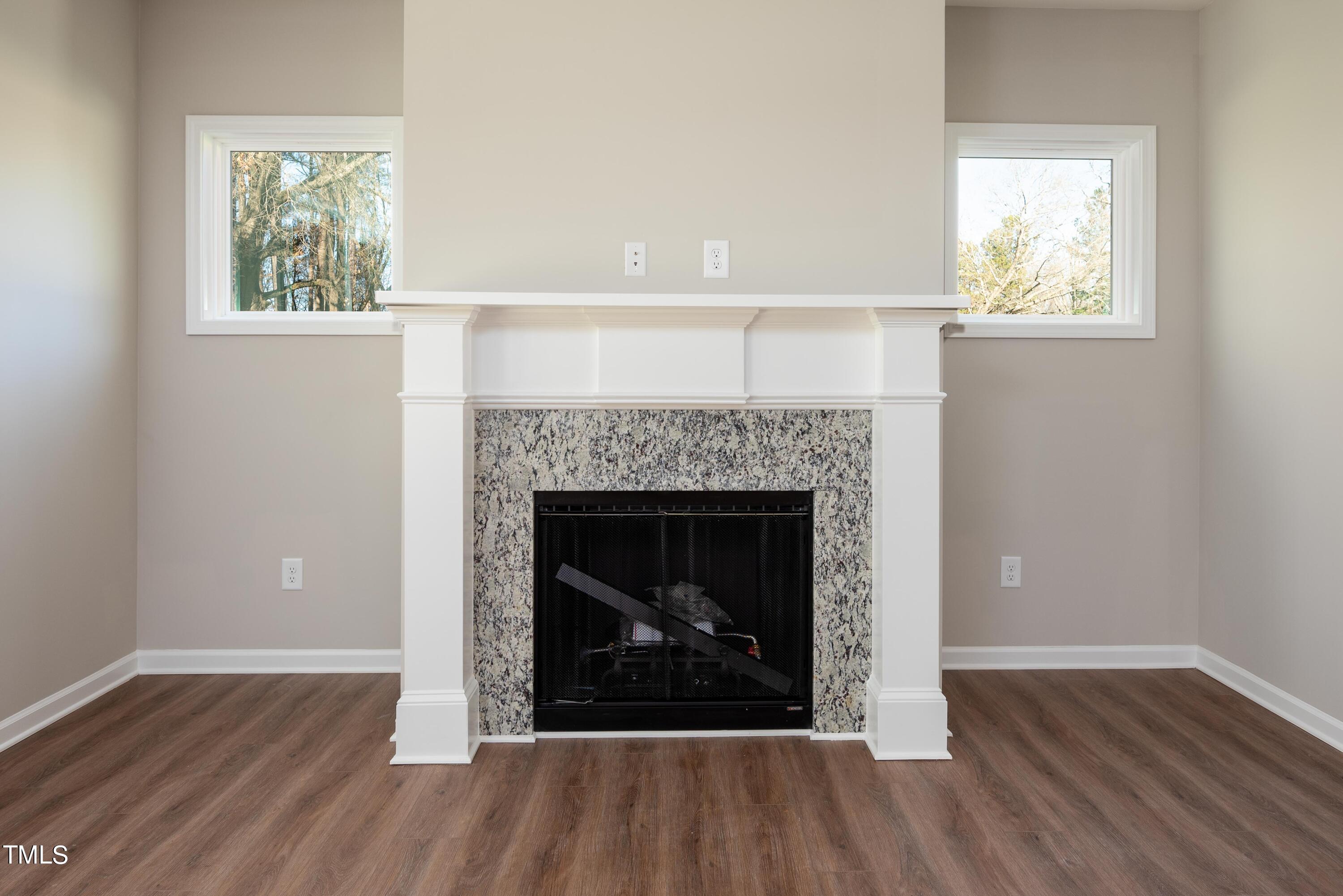 5080 Frazier Road Middlesex, NC 27557 - Photo 5 of 39 a living room with a fireplace and wooden floor