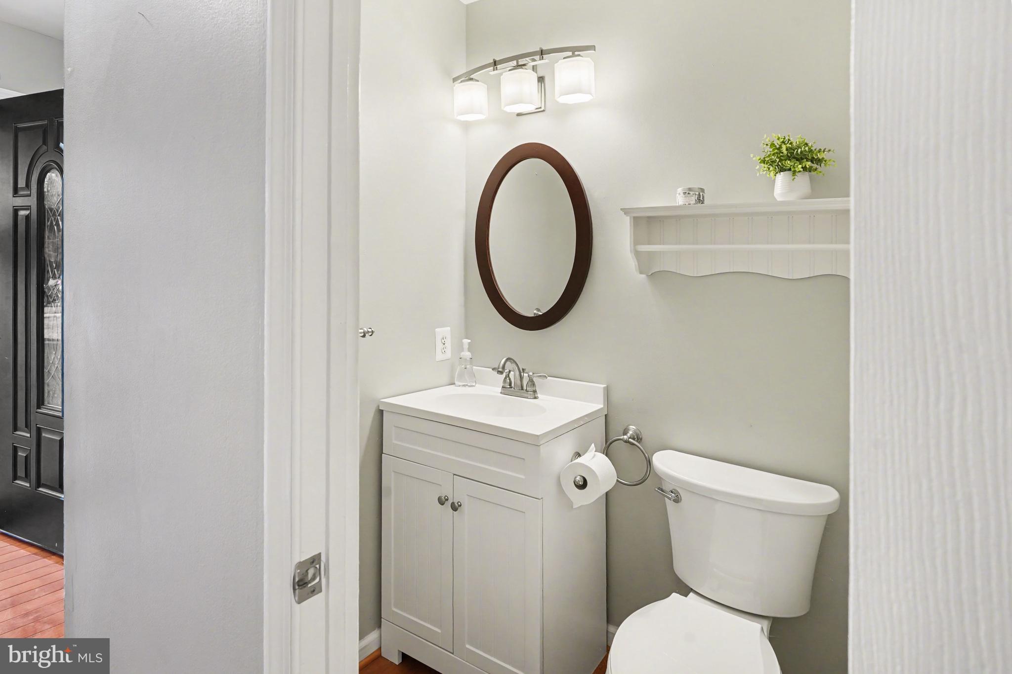 219 Twining Road Lansdale, PA 19446 - Photo 14 of 39 a bathroom with a toilet a sink and a mirror