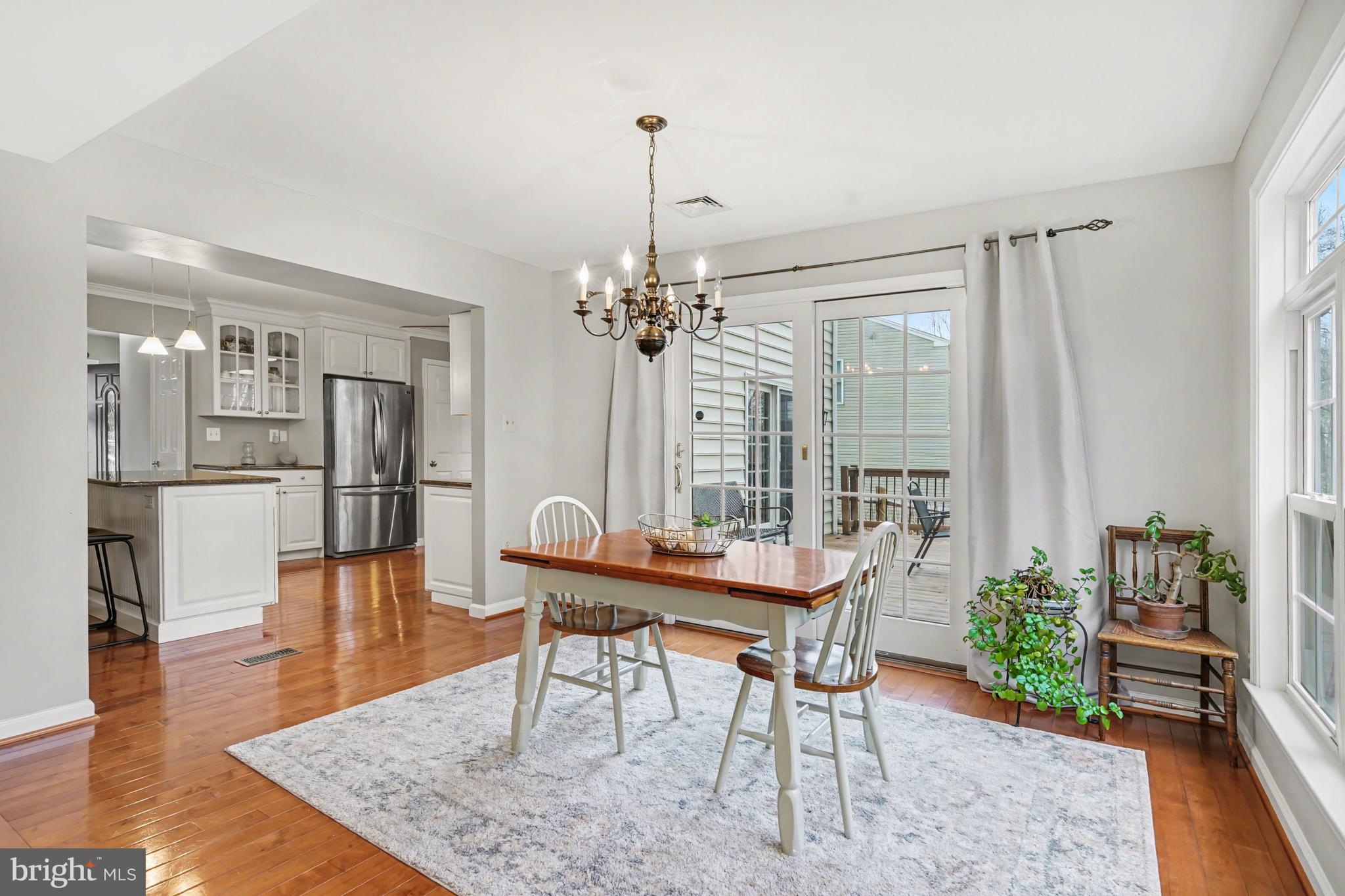 219 Twining Road Lansdale, PA 19446 - Photo 16 of 39 a dining room with furniture a chandelier and wooden floor