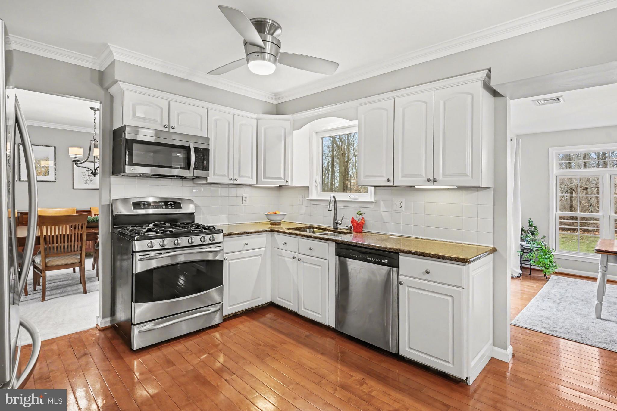 219 Twining Road Lansdale, PA 19446 - Photo 9 of 39 a kitchen with granite countertop a stove a sink and a microwave