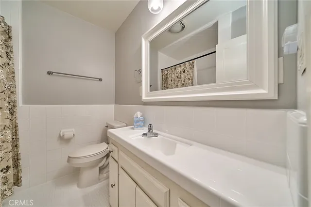 a bathroom with a sink toilet and mirror