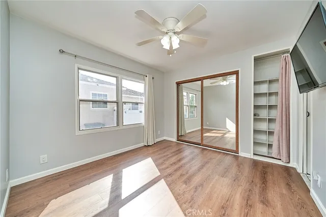a room with stainless steel appliances wooden floors and fireplace