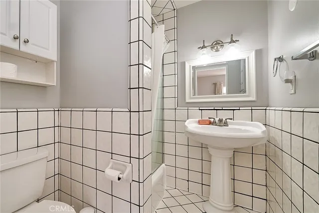 a kitchen with a stove a refrigerator and wooden floor
