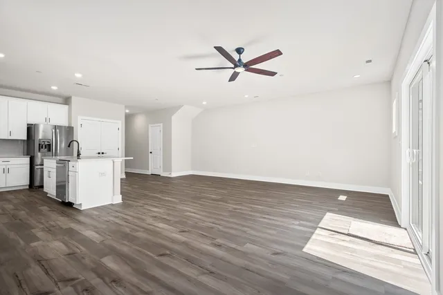 a view of kitchen with furniture and refrigerator