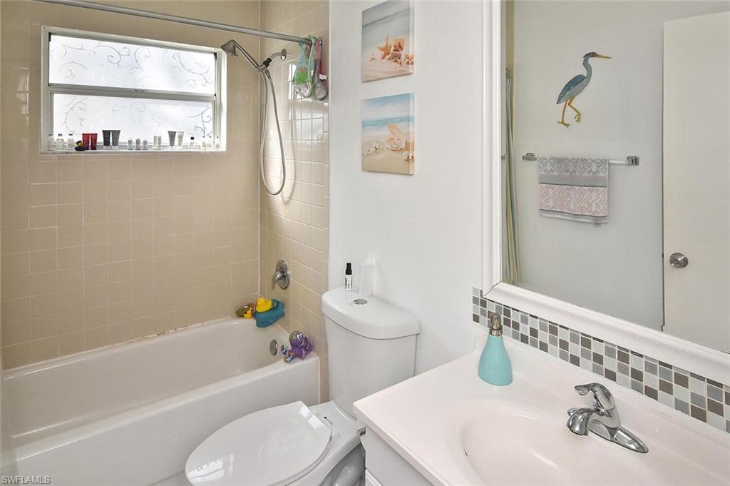 1895 Courtyard Way, Unit B103 Naples, FL 34112 - Photo 17 of 32 a bathroom with a sink toilet and shower
