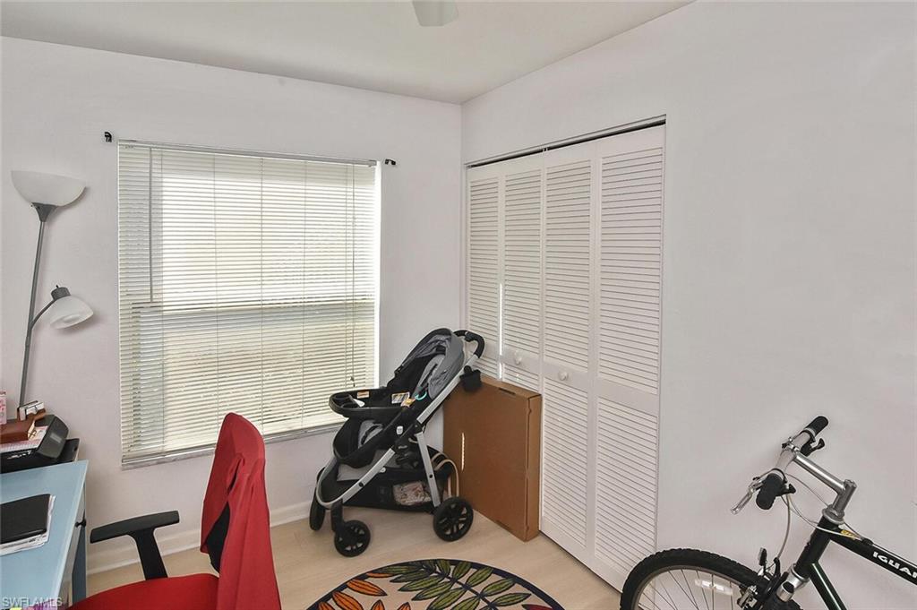 1895 Courtyard Way, Unit B103 Naples, FL 34112 - Photo 19 of 32 a view of a workspace with furniture and a window