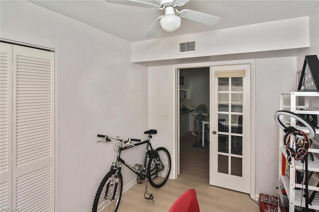 1895 Courtyard Way, Unit B103 Naples, FL 34112 - Photo 20 of 32 a view of an room with wooden floor and windows