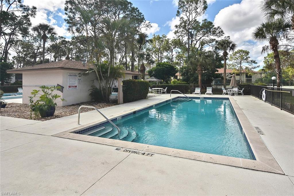 1895 Courtyard Way, Unit B103 Naples, FL 34112 - Photo 29 of 32 a view of a swimming pool with a patio