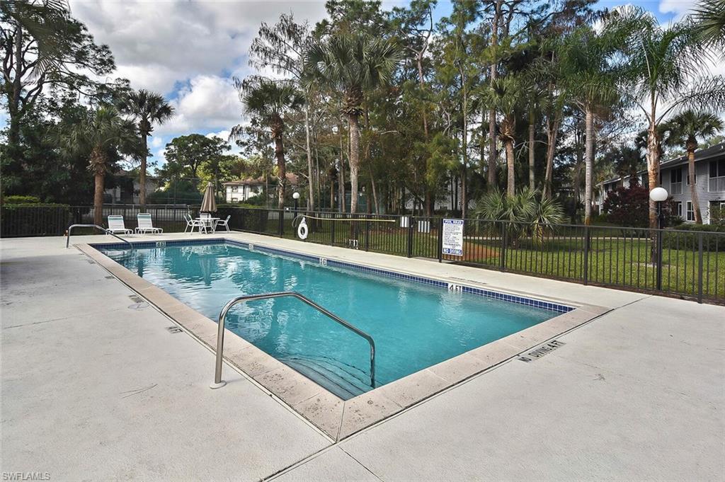 1895 Courtyard Way, Unit B103 Naples, FL 34112 - Photo 31 of 32 a view of swimming pool with outdoor seating and plants
