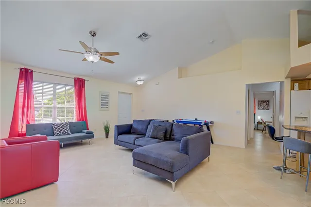 a living room with furniture a flat screen tv and a window