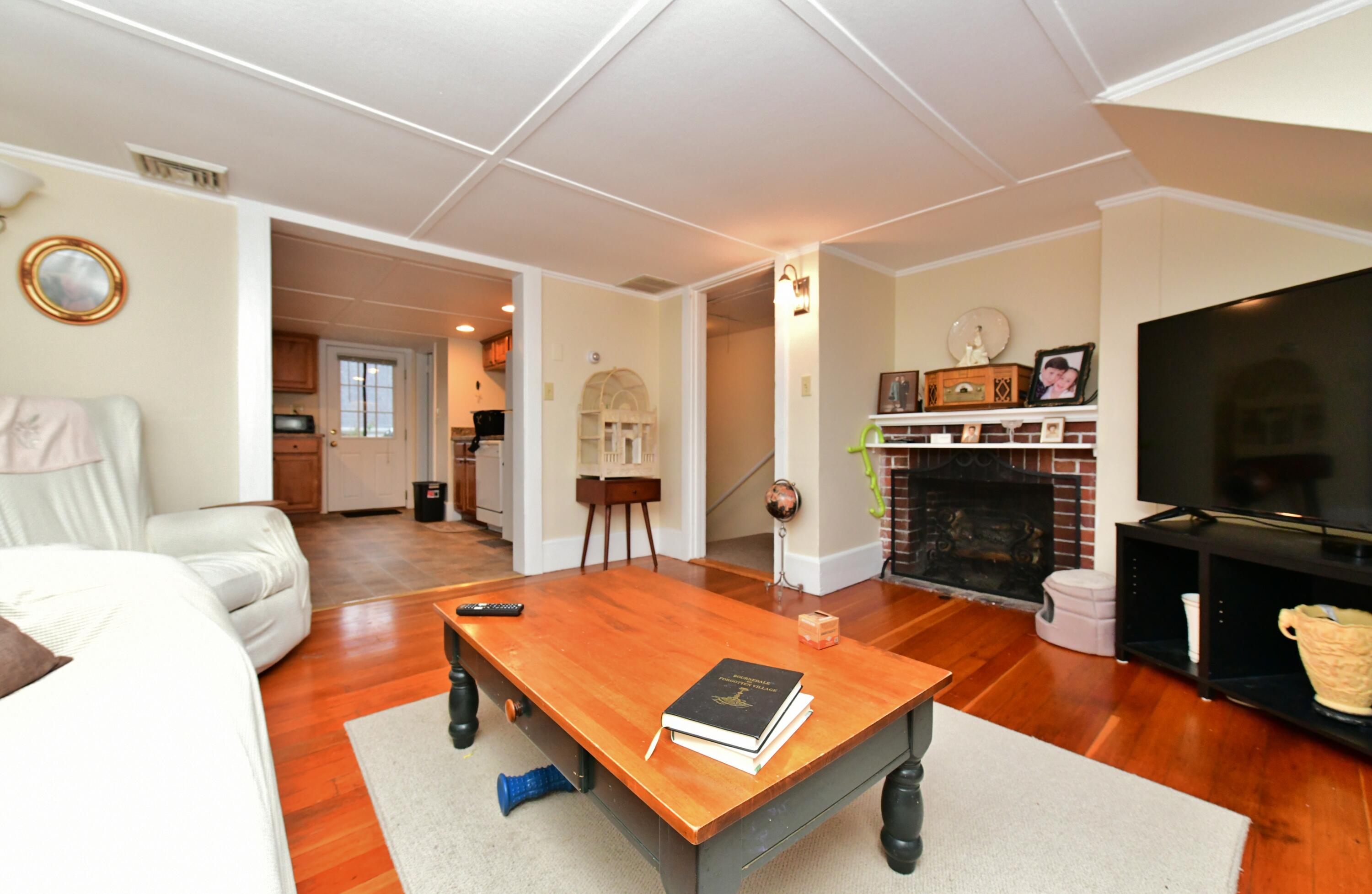 6 Bournedale Road, Unit 6B 2 Buzzards Bay, MA 02532 - Photo 11 of 36 a living room with furniture pool table and a flat screen tv