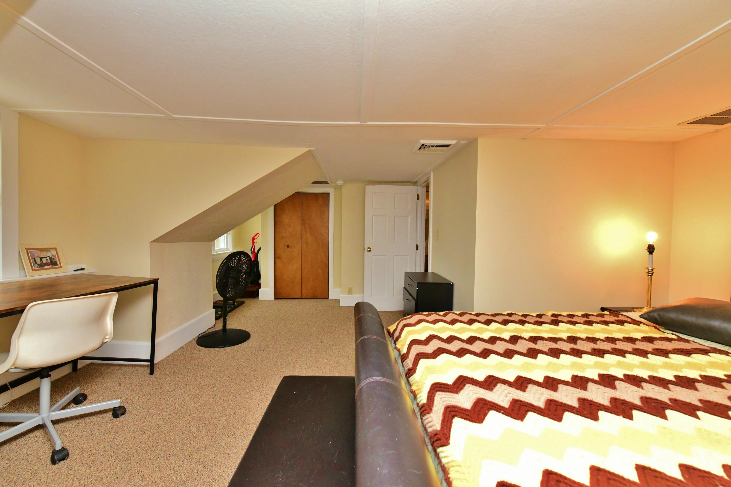 6 Bournedale Road, Unit 6B 2 Buzzards Bay, MA 02532 - Photo 14 of 36 a bedroom with a bed and a chair in it