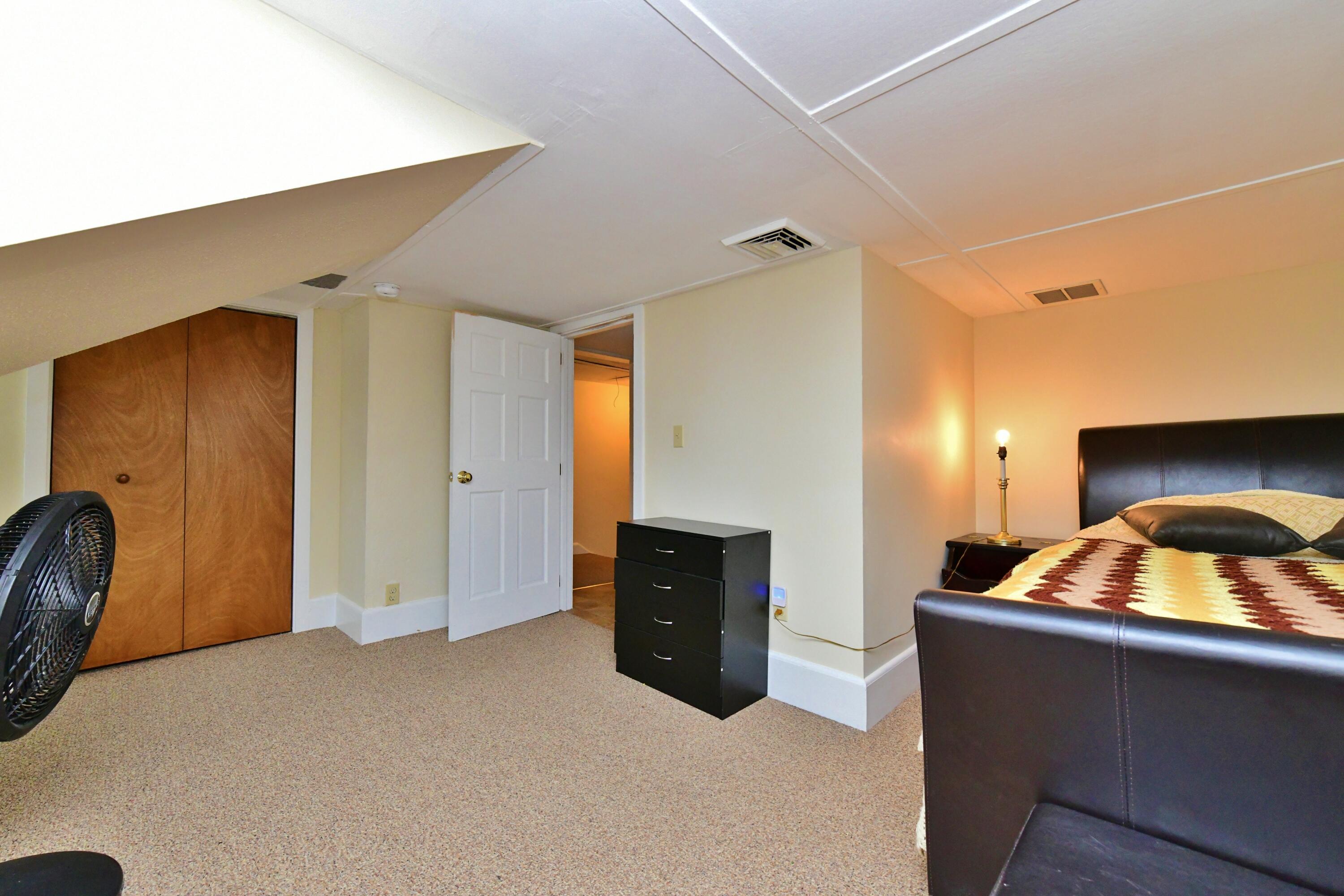 6 Bournedale Road, Unit 6B 2 Buzzards Bay, MA 02532 - Photo 16 of 36 a bedroom with a bed and cabinets