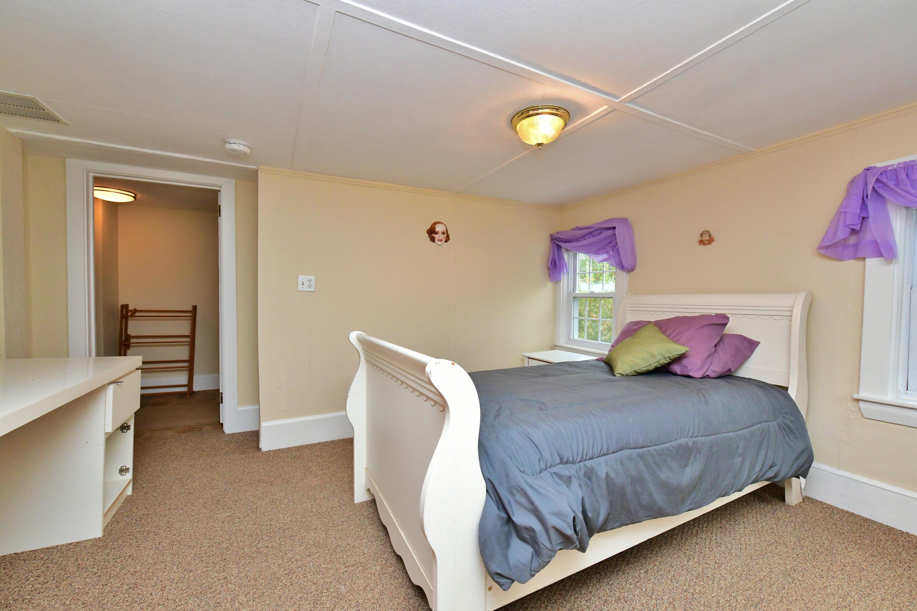 6 Bournedale Road, Unit 6B 2 Buzzards Bay, MA 02532 - Photo 20 of 36 a bedroom with a bed and a refrigerator