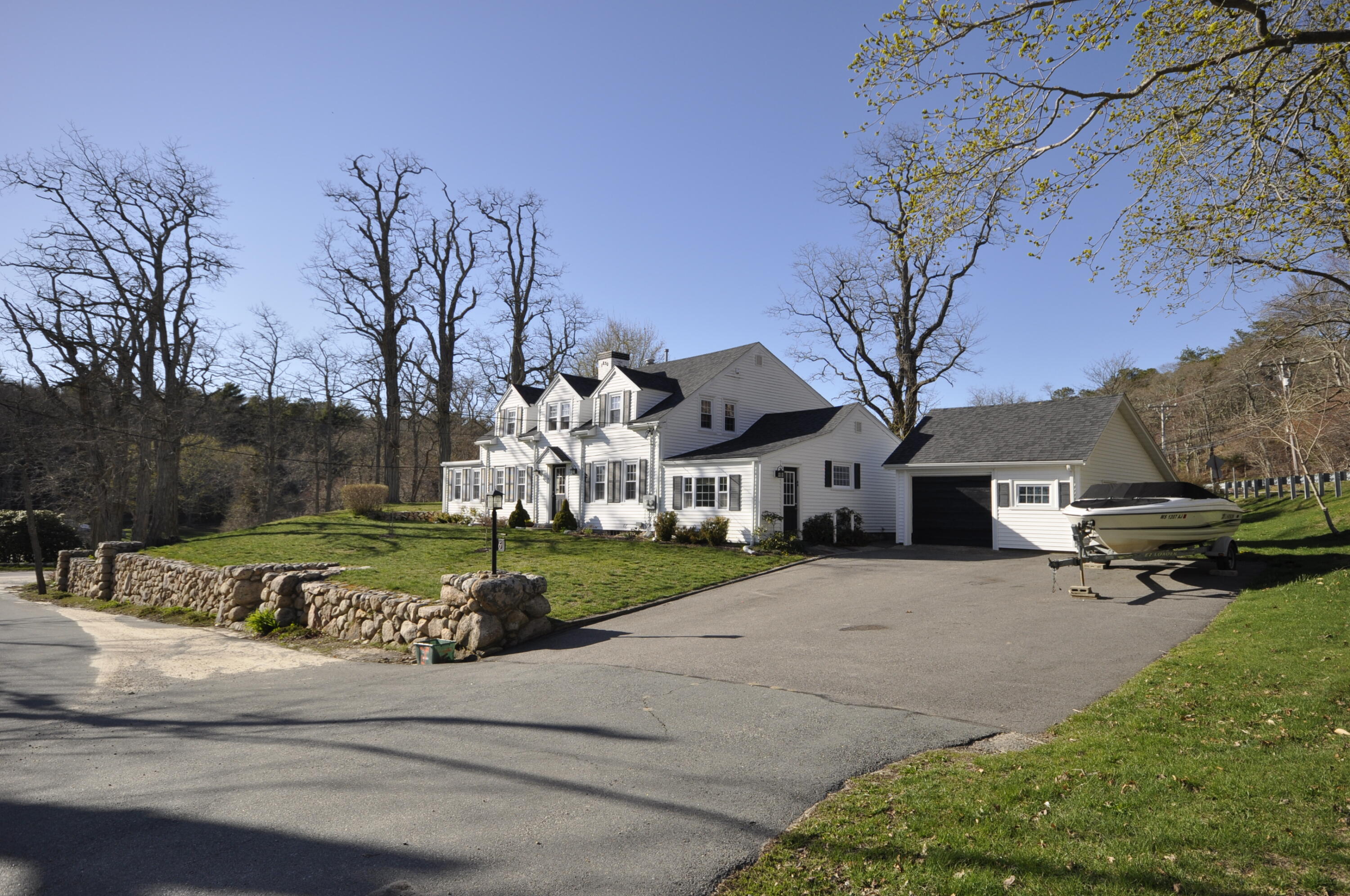 6 Bournedale Road, Unit 6B 2 Buzzards Bay, MA 02532 - Photo 27 of 36 a front view of a house with a yard and garage