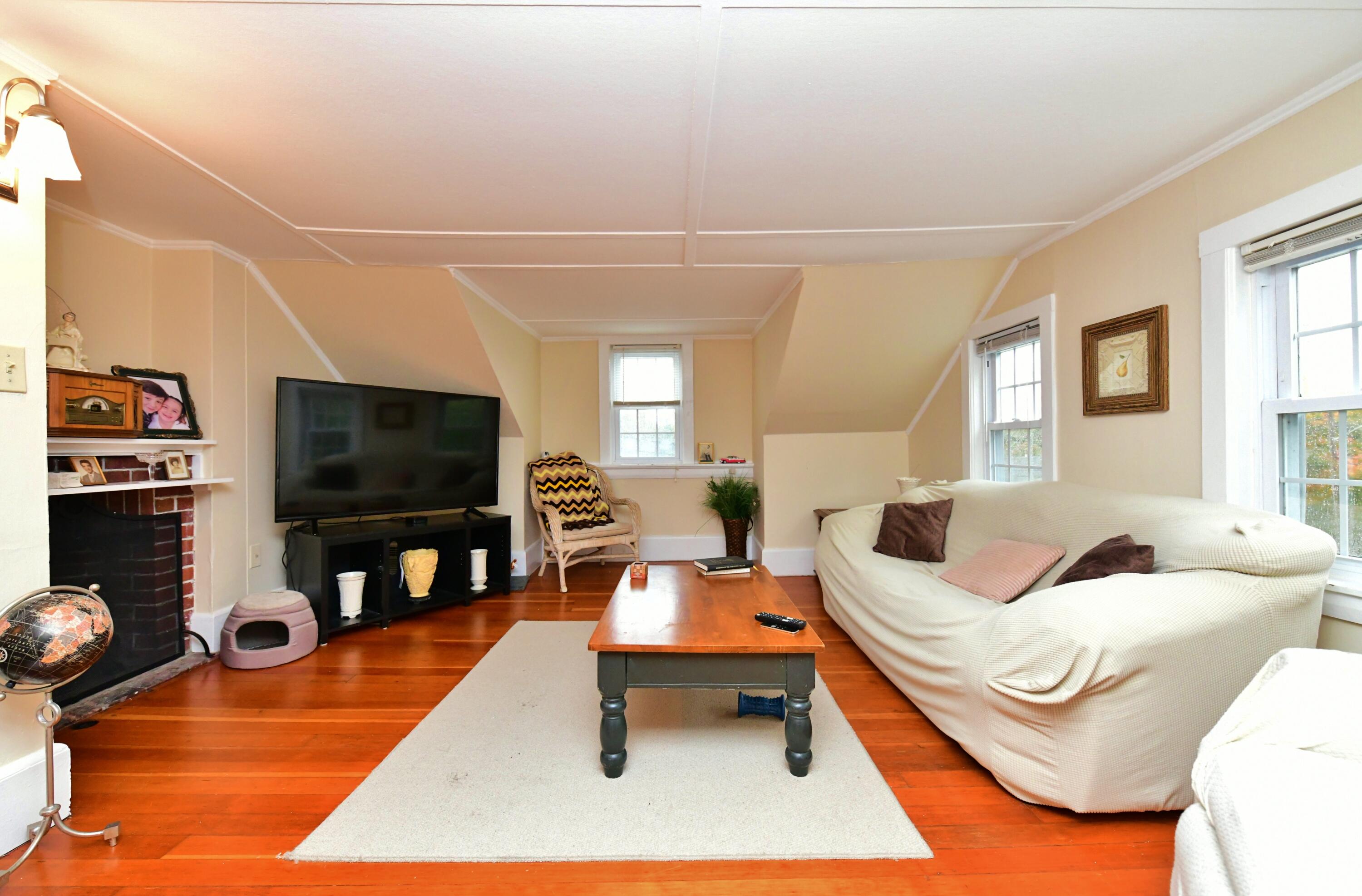 6 Bournedale Road, Unit 6B 2 Buzzards Bay, MA 02532 - Photo 8 of 36 a living room with furniture and a flat screen tv